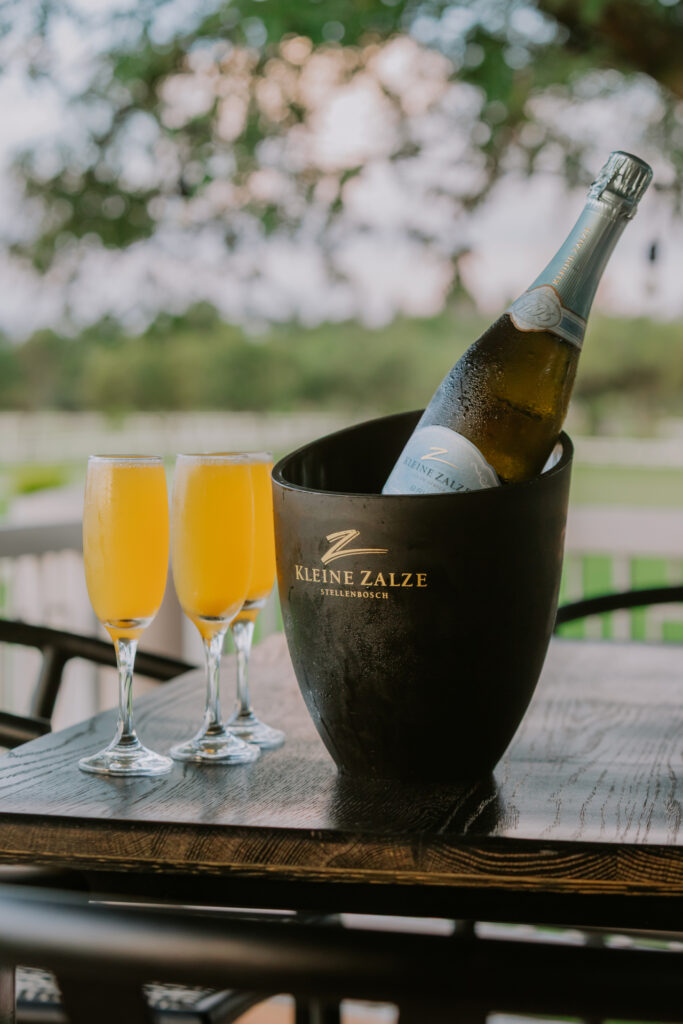 Bottomless Mimosa cocktails served on and outside deck with a view in Lonehill at TLC on the Track.